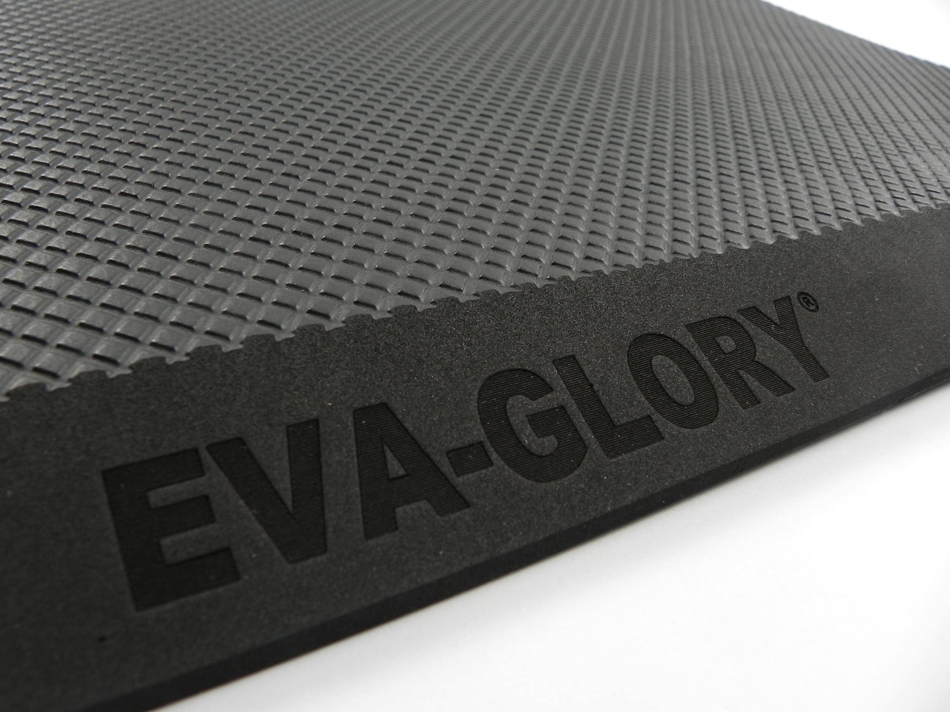 Close-up of a textured commercial anti-fatigue floor mat with a laser-engraved EVA-GLORY logo on the edge